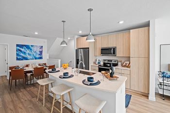 An open kitchen and dining area with a white counter top